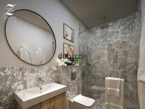 Own and invest in a 57-meter finished studio with air conditioning in Zed Towers Sheikh Zayed at a very special price