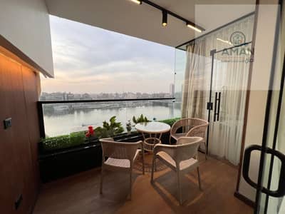 A luxurious apartment in Al-Akshid Street, Manil El-Roda, parallel to Abdul Aziz Al-Saud Street, with a Nile view from the balcony.