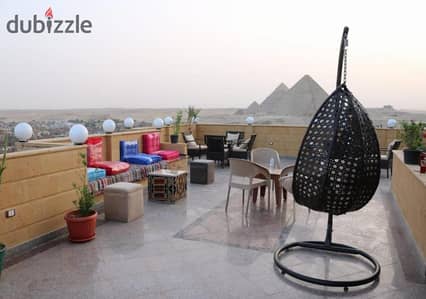 Seize the opportunity to own a premium rooftop unit with an open outdoor area overlooking the Pyramids, offering the highest daily rental return in US