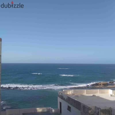 Apartment for rent furnished in Miami, side view of the sea and the corniche. The apartment consists of two bedrooms, a reception area, and three balconies with an elevator. The entrance to the building is chic.