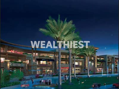Commercial shop for sale with down payment and installments in Madinaty All Seasons Park prime location directly in front of Carrefour on main street