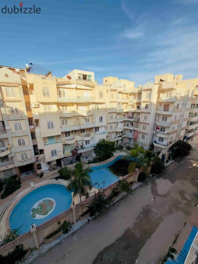 Apartment for sale in Alexandria, Al-Nakheel Beach, fully furnished and equipped, overlooking a swimming pool, distinguished residential and summer location