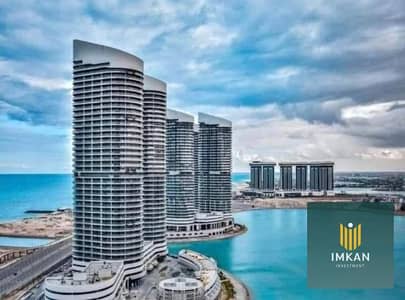 شقه للبيع بمقدم 5% Double sea and lagoon views بالتقسيط حتى 12 سنه متشطبه بالتكييفات واستلام فوري في ابراج العلمين ALAMIN TOWERS في العلمين الجديده