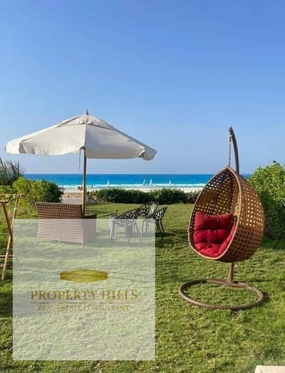 10-year installment plan on a townhouse villa in the North Coast with a large lagoon view and panoramic view, fully finished with air conditioning.