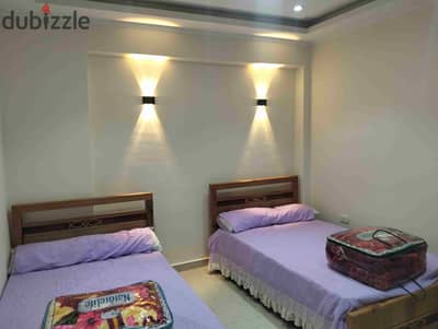 Furnished apartment with new furniture for secondary rent 3 bedrooms 6 beds reception two pieces kitchen bathroom first upper floor all facilities available water electricity and natural gas in Alexandria Al-Ajami kilo 21 October entrance before the gate at a very distinguished location