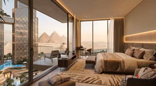 Fully finished serviced apartment for sale with furniture & appliances, overlooking the Pyramids, with installments up to 15 years in 6th of October