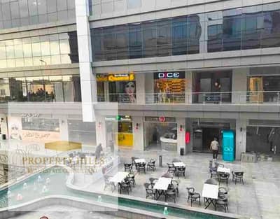 Shop for sale, currently rented with a monthly return of 115,000 (currency unspecified) with annual increases. Immediate occupancy available in Fifth Settlement.