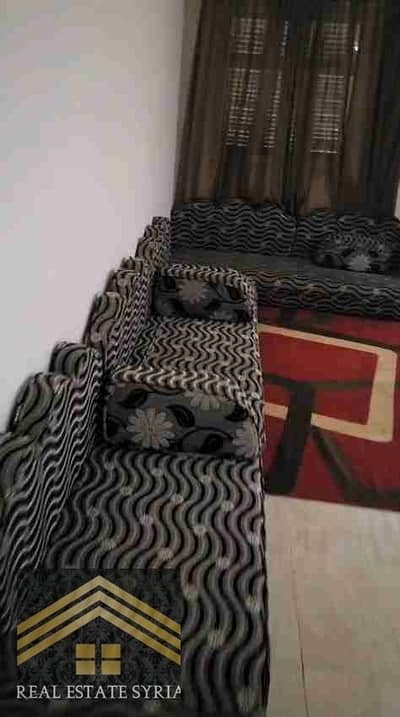 Furnished apartment in social housing suitable for engineers, students, and families, with air conditioning on the first floor. The couch is Arabic and faces the two rooms. 9,000. There is also a ground floor in the same building with two non-air-conditioned rooms for 8,000.