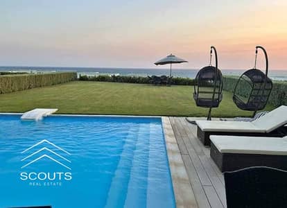 First row on the sea and lagoon, chalet for sale at a bargain price opposite Alamein Towers, fully finished, with a direct sea view in the New Alamein