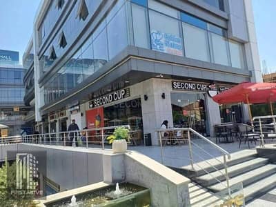 A unique investment opportunity! Own a 58m² shop with a 27m² outdoor area in the heart of New Cairo's Fifth Settlement with a 36% discount