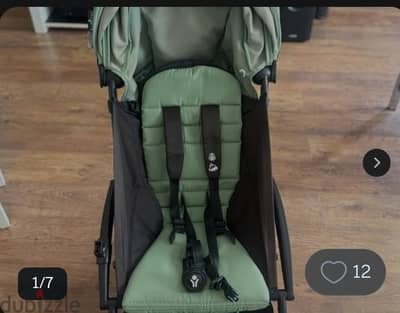 Babyzen YOYO stroller featuring a green seat pack and a black frame.