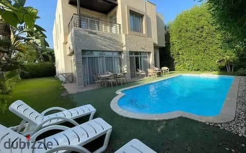 Luxury townhouse for sale in Al Shorouk, immediate delivery, with a stunning view of the swimming pool and landscape.