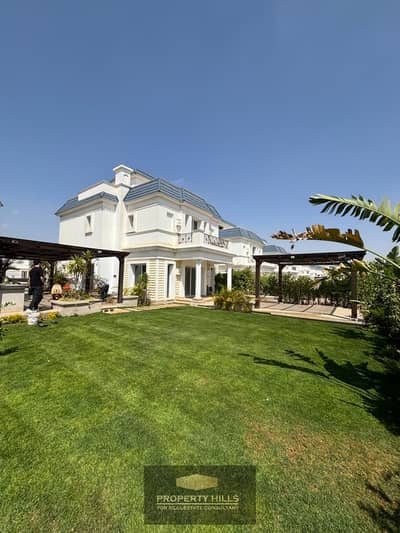 A standalone villa with hotel finishing and a swimming pool overlooking the lakes next to Rios in front of new giza near Al-Jazira Club
