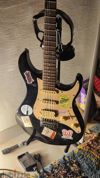electric guitar + amplifier