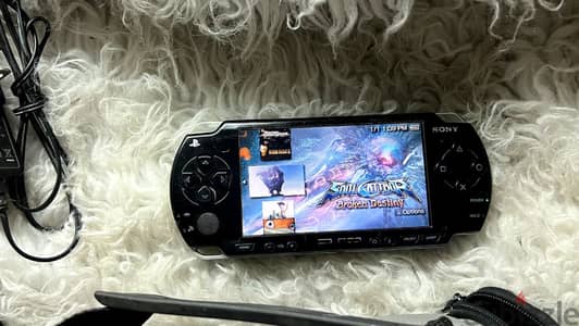psp 2000 slim +لعبة300 +شاحن 64 جيجا +بطارية