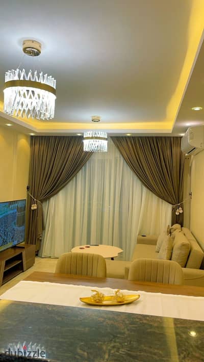 Furnished Apartment for Rent – Madinaty, B12  - Area: 87 sqm - Layout: Ground floor with private garden - 2 Bedrooms - 1 Bathroom - Reception area - American-style kitchen  Features:  - Fully air-conditioned - Luxury furniture and modern appliances - Hote