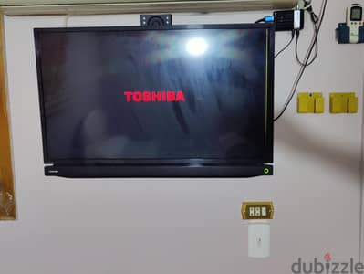 Toshiba TV with original remote, TV Box, TV Mount, and Satellite Dish