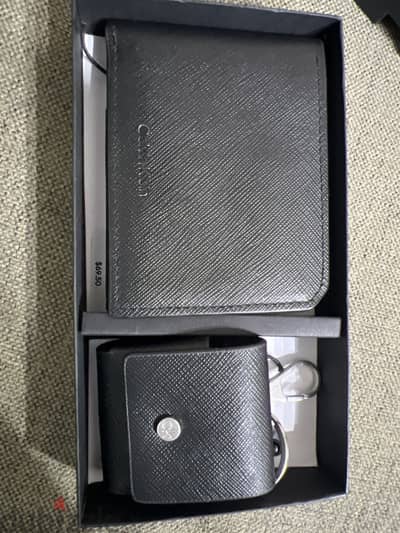 Calvin Klein wallet and AirPods 1 case