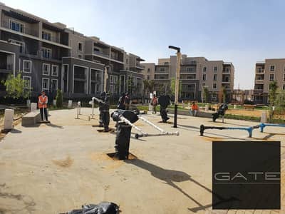 Ground floor apartment with garden for sale in Sodic October Plaza  Direct view of the infinity pool | Fully integrated compound, ready to move