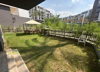 Apt with private garden ,Furnished, ready to move and in a prime location In Aura Compound Cairo Festival, 5th Settlement, New Cairo