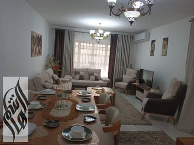 124 SQM furnished apartment in Madinaty B6, ground floor with 50 SQM private garden, modern furniture, wide garden view.