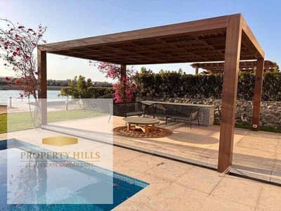 A fully finished stand-alone villa (1,400,000) in a compound of villas only with a landscape view on the Suez Road, wall to wall with Sodic East