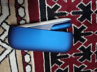 IQOS 3 DUO tobacco heating device in a blue color.
