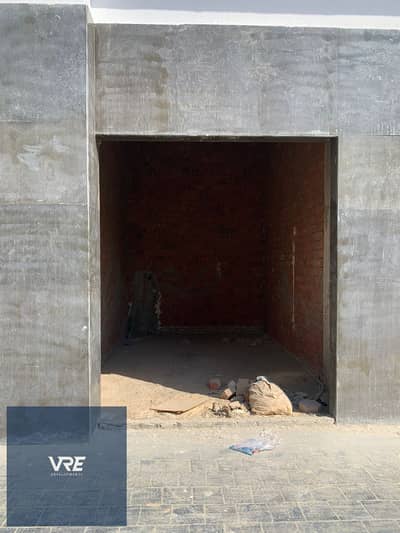 Shop for sale in Al Shorouk, suitable for a cafe or restaurant | Prime location and direct installment plan