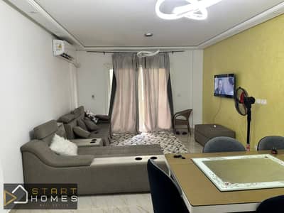A distinctive 115-square-meter, 3-bedroom furnished apartment for rent in Madinaty B12, boasting a stunning green view and high-end finishes.