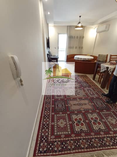Furnished apartment for rent in Al-Rehab 2 with special finishing, hotel furniture next to all services and malls, completely unobstructed view.
