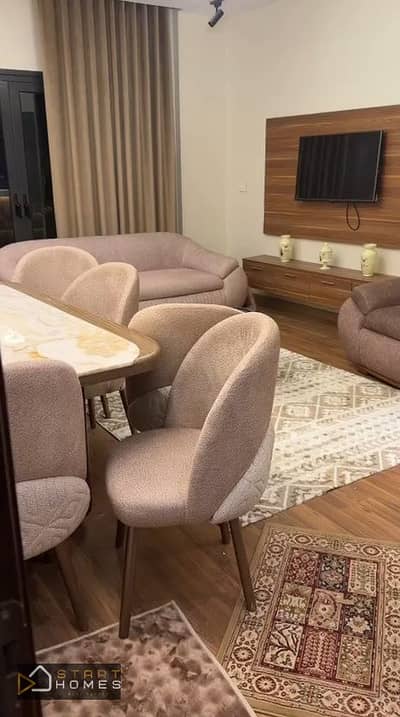 Furnished 100-square-meter, two-bedroom apartment for rent in Privado, Madinaty. It features a garden view and is located next to All Seasons Park, cl