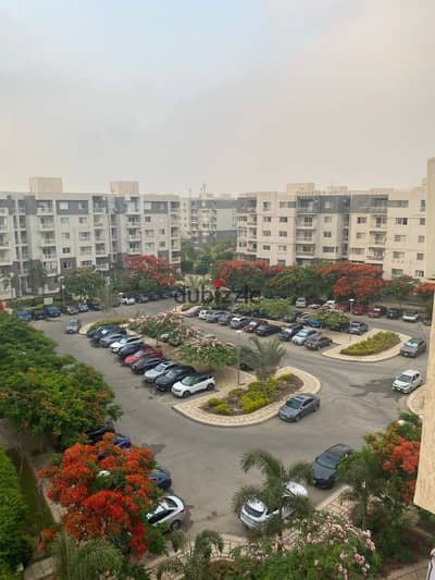 Apartment in Madinaty (B10), prime location directly facing "The Spine" and overlooking a wide garden; fully paid off, with original developer finishing.