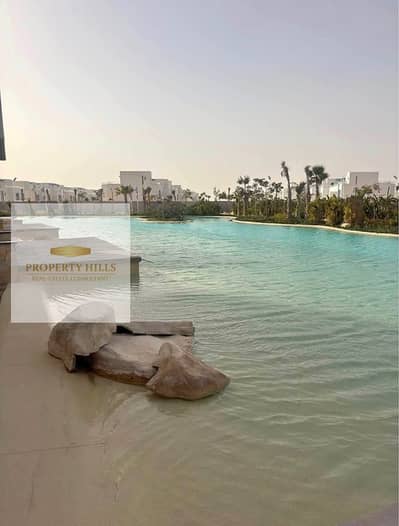 Chalet in a large garden with super lux finishing, with an open view and a distinctive view of the lagoon for sale at the old price with a very nice division or by installments over the longest payment period.