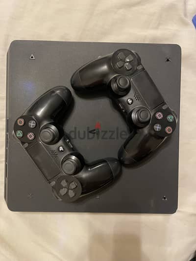 Playstation 4 with 2 original controllers and 5 games.