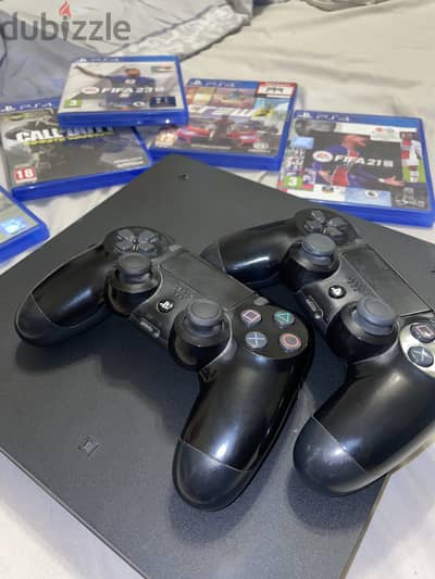 Playstation 4 with 2 original controllers and 5 video games