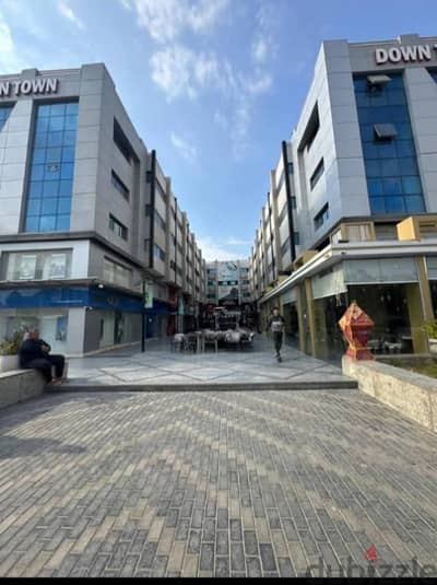 محل 100م دورين للإيجار في داون تاون الشيخ زايد بجوار QNB