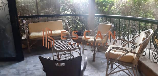 Ground floor apartment with garden for sale in Phase 9 of Al Rehab, ready to move in with furniture and appliances