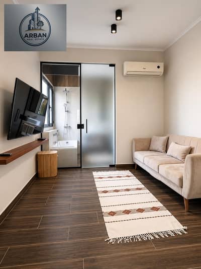 Furnished hotel studio for rent in Sarayat Al-Maadi, Al-Hadaiq Street, amidst trees and villas next to restaurants and global brands