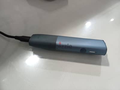 IQOS ILUMA ONE heated tobacco device, likely in the Azure Blue color.