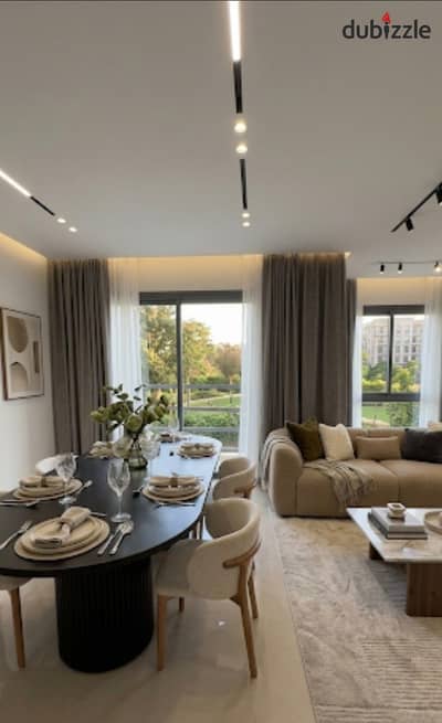 Finished ground floor apartment with garden for sale, ready to move, in Village West Compound, Sheikh Zayed