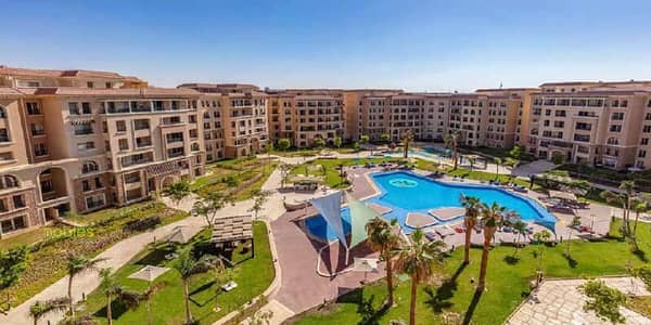 Apartment with a garden, fully finished, ready to move, in a prime location next to the American University in 90 Avenue Compound new Cairo
