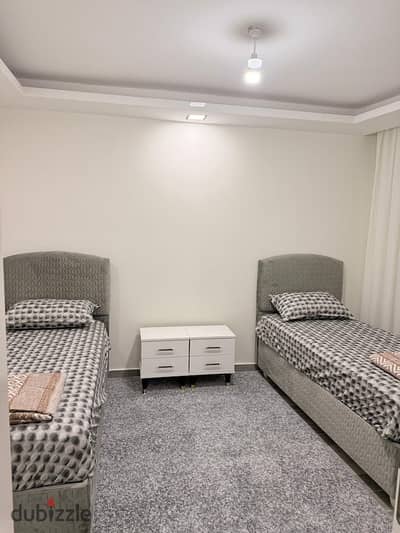 Next to the British University in the seventh district, Al-Shorouk, a furnished studio with a private garden and a private entrance, fully equipped, superlux