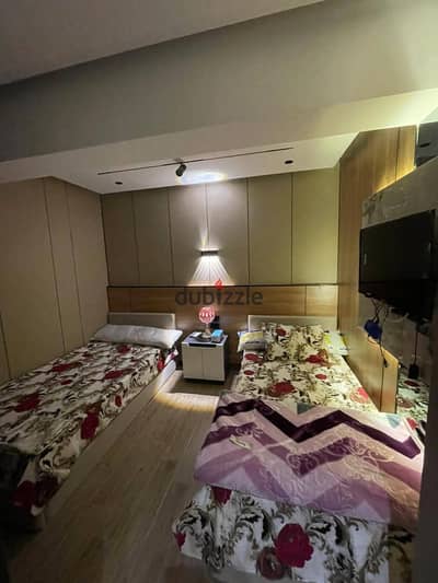 Studio for rent in the best location in 6th October City, 1st district, next to all services: hospitals, cafes, restaurants, schools, and universities. The studio consists of 2 beds, a wardrobe, a carpet, a fridge, a stove, a washing machine, a kitchen, a 43-inch smart screen, hot and cold AC, an electric water heater. We have more than one furnished studio.