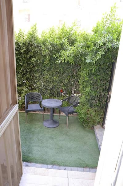 84 sqm ground-floor apartment with a garden for furnished rent in the Hadayek Al-Mohandessin compound, Sheikh Zayed.