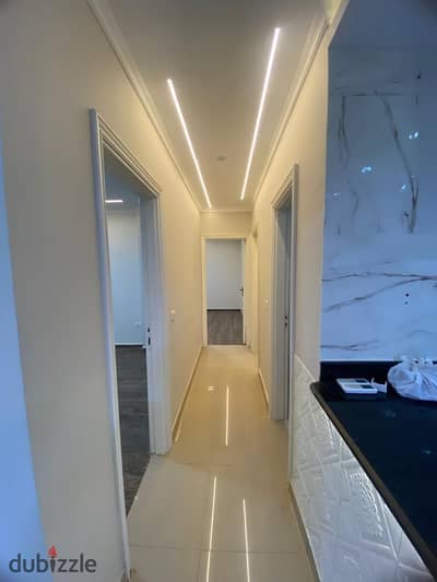 For rent in my city, a fully finished luxury apartment on the ground floor, 130 meters with a private garden of 55 meters, garden view next to the malls.