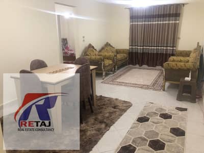 A distinctive furnished apartment for rent on the first floor with a garden view, opposite the International School in Gardenia City Compound, Nasr Ci