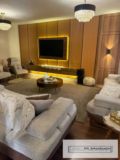 Freehold apartment for sale in Al Rehab City, New Cairo; features a wide garden view and custom, high-end finishes throughout.