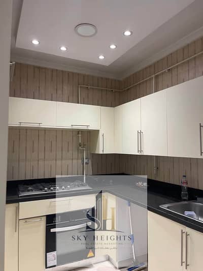 An empty apartment for rent in a prime location in front of the Eastern Market in Rehab City. The kitchen is included in the rent.