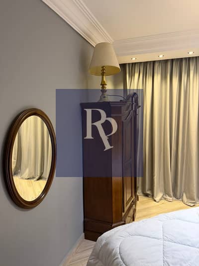 Luxury furnished apartment for rent in Taj Sultan inside Taj City, ground floor with private garden, spacious areas, and modern furnishings in one of the best locations in New Cairo 
