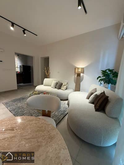 Fully furnished 100-square-meter, two-bedroom apartment for rent in Privado, Madinaty; features custom finishes and brand-new furniture and appliances